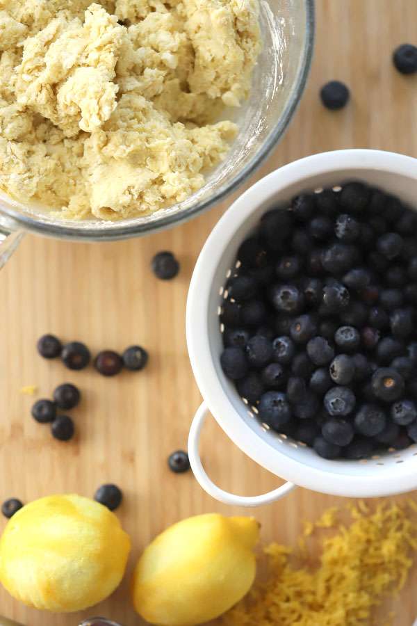 Einkorn Lemon Blueberry Scone dough in a bowl and a bowl of berries