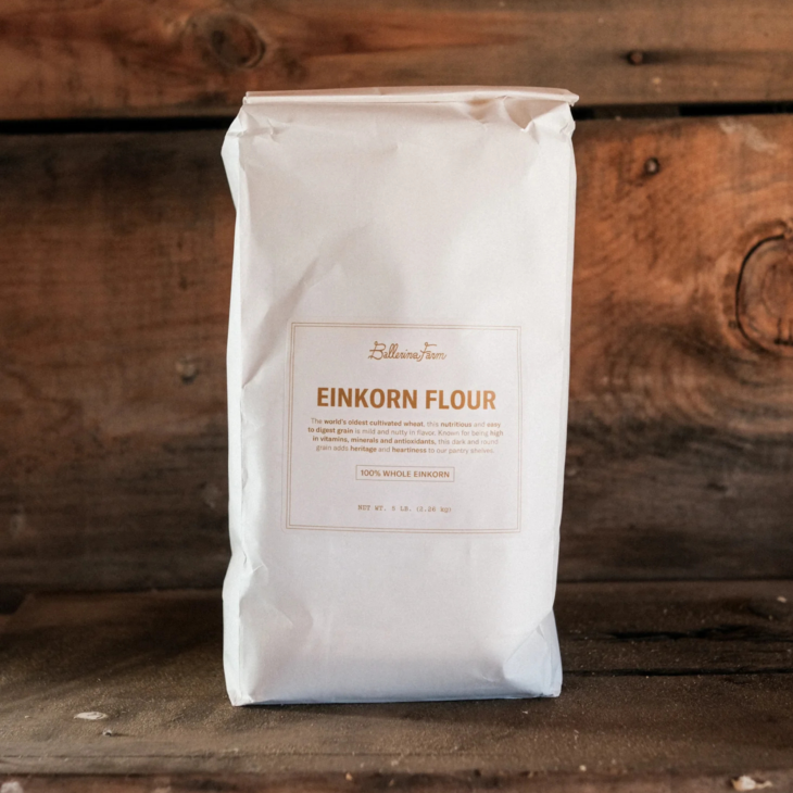White bag of Ballerina Farm Einkorn Flour on a wooden surface.