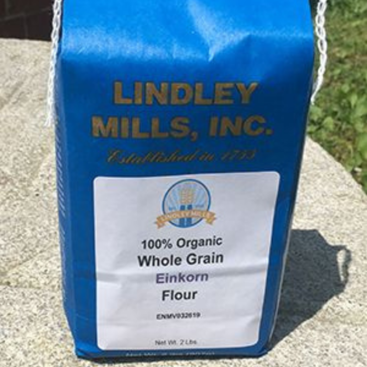  Blue bag of Lindley Mills 100% Organic Whole Grain Einkorn Flour, photographed outdoors.